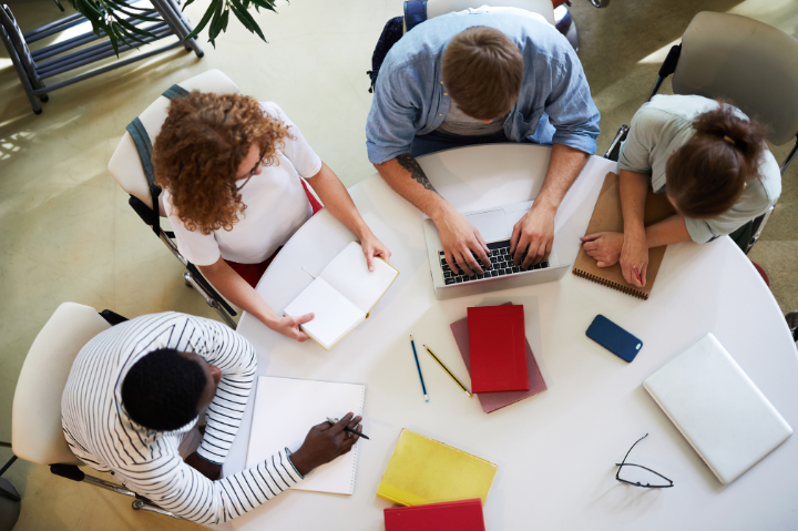 Birds eye view of a group of learners sitting around a table.